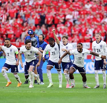 Players of England celebrate after Trent Alexander-Arnold of England (not pictured) scores the team's fifth and winning penalty in the penalty shoot out during the UEFA EURO 2024 quarter-final match between England and Switzerland