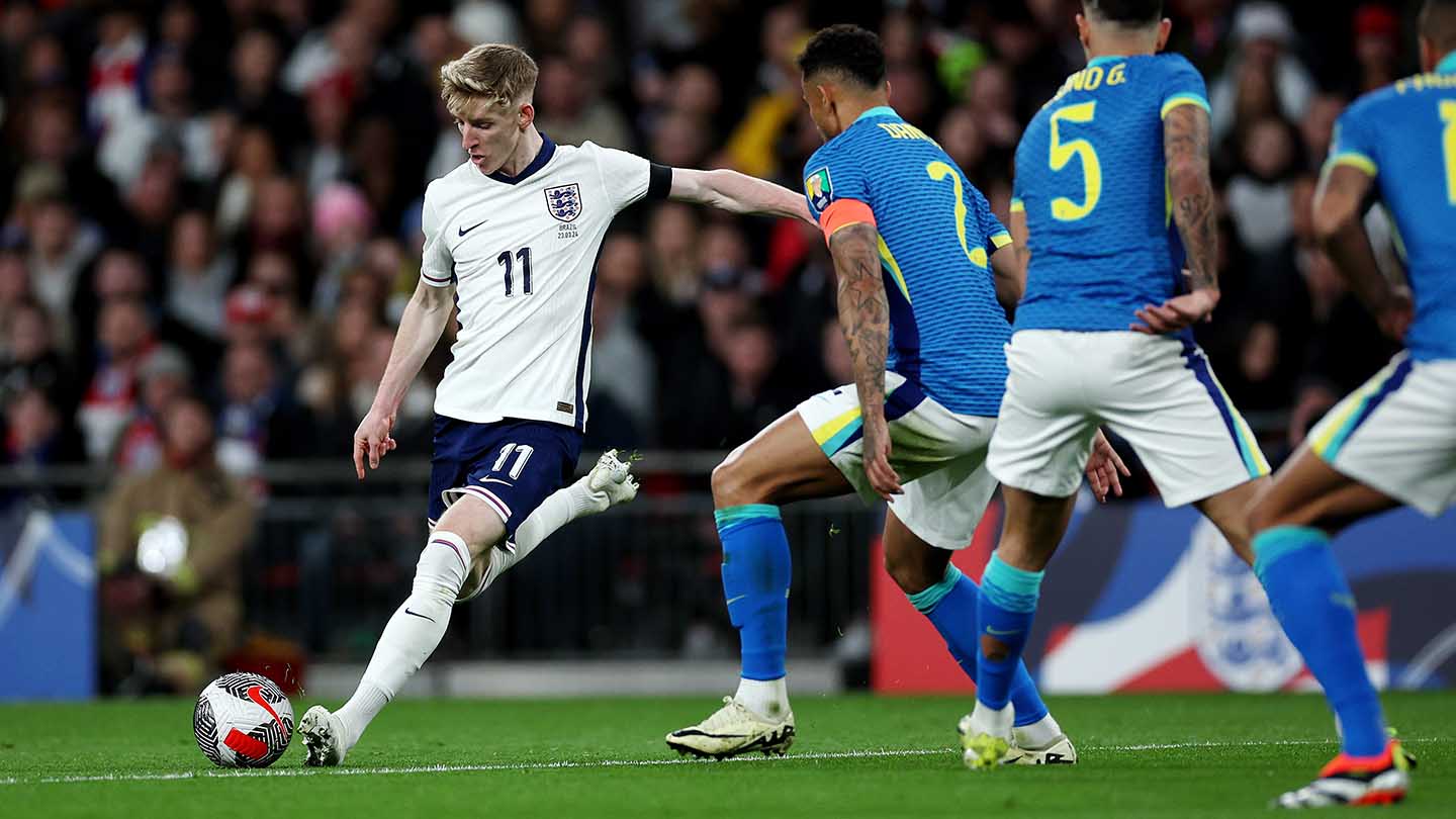 Anthony Gordon of England shoots under pressure from Danilo of Brazil during the international friendly match at Wembley